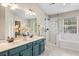 A well-lit bathroom with double sinks, a glass enclosed shower, and a luxurious bathtub at 1337 Horseshoe Bnd, Mount Pleasant, SC 29464