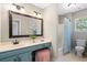 A well-lit bathroom features a white vanity, a framed mirror, and a toilet next to the shower at 1337 Horseshoe Bnd, Mount Pleasant, SC 29464