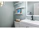 Well-lit bathroom with a modern sink and vanity, and decorative wall shelves at 1337 Horseshoe Bnd, Mount Pleasant, SC 29464