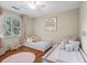 ' bedroom with two twin beds, hardwood flooring, polka dot wallpaper, and a ceiling fan at 1337 Horseshoe Bnd, Mount Pleasant, SC 29464