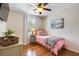 A well-lit bedroom features a picture hanging on the wall and a desk with a plant on it at 1337 Horseshoe Bnd, Mount Pleasant, SC 29464