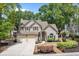 Charming two-story home featuring a two-car garage, manicured lawn, and inviting front entrance with a blue door at 1337 Horseshoe Bnd, Mount Pleasant, SC 29464