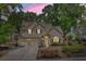 Charming two-story home boasts a two-car garage and lush front yard landscaping at sunset at 1337 Horseshoe Bnd, Mount Pleasant, SC 29464