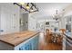 Modern kitchen with white cabinets, stainless steel appliances, and a wood-topped island connected to the breakfast area at 1337 Horseshoe Bnd, Mount Pleasant, SC 29464