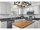 Modern kitchen with white cabinets, stainless steel appliances, and a wood-topped island at 1337 Horseshoe Bnd, Mount Pleasant, SC 29464