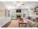 Cozy living room features a brick fireplace, built-in shelving, and a ceiling fan at 1337 Horseshoe Bnd, Mount Pleasant, SC 29464