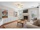 Inviting living room with a fireplace, built-in shelving, and hardwood floors at 1337 Horseshoe Bnd, Mount Pleasant, SC 29464