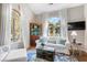 Sunlit living room featuring hardwood floors, arched windows, and stylish furnishings, creating an inviting and comfortable space at 1337 Horseshoe Bnd, Mount Pleasant, SC 29464