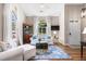 Bright living room showcasing hardwood floors, high ceilings, arched windows, and stylish decor, creating a relaxing atmosphere at 1337 Horseshoe Bnd, Mount Pleasant, SC 29464