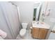 Bathroom with a toilet, curtained shower, and sink with wood cabinetry at 139 Spindle Way, Goose Creek, SC 29445