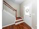 Home entryway showcasing hardwood floors, staircase with wood railing, and white front door at 139 Spindle Way, Goose Creek, SC 29445