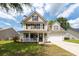 Charming two-story home featuring a covered front porch, well-maintained lawn, and attached two-car garage at 139 Spindle Way, Goose Creek, SC 29445