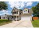 Beautiful two-story house with a covered front porch, attached garage, and well-maintained lawn under a blue sky at 139 Spindle Way, Goose Creek, SC 29445
