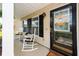 Cozy covered front porch with rocking chairs, a decorative front door, and a welcoming ambiance at 139 Spindle Way, Goose Creek, SC 29445