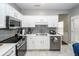 Modern kitchen with white cabinets, stainless steel appliances, and marble floors at 139 Spindle Way, Goose Creek, SC 29445