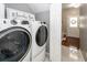 Laundry room with a modern washer and dryer set next to a doorway at 139 Spindle Way, Goose Creek, SC 29445