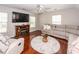 Inviting living room featuring hardwood floors, a cozy fireplace, and ample natural light from the windows at 139 Spindle Way, Goose Creek, SC 29445