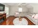 A cozy living room features a large sectional, fireplace, and hardwood floors, perfect for relaxing at 139 Spindle Way, Goose Creek, SC 29445