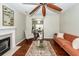 Elegant living room with a fireplace, hardwood floors, stylish furniture, and a ceiling fan at 139 Spindle Way, Goose Creek, SC 29445