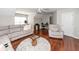 Bright living area with modern furniture, a work desk and chair, and hardwood flooring at 139 Spindle Way, Goose Creek, SC 29445