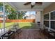 Relaxing screened-in porch area, complete with fan and outdoor seating, and views of the backyard at 139 Spindle Way, Goose Creek, SC 29445