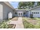 A private yard with a walkway leads to a garage, creating a serene outdoor living space at 1406 Glencoe Dr, Mount Pleasant, SC 29464