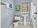 Bathroom with a pedestal sink, wooden toilet seat, and colorful shower curtain at 1406 Glencoe Dr, Mount Pleasant, SC 29464