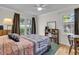 Cozy bedroom with a patterned quilt, wood floors, and natural light from two windows at 1406 Glencoe Dr, Mount Pleasant, SC 29464