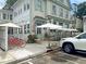 Charming cafe exterior with outdoor seating, white picket fence, and red bicycles parked outside at 1406 Glencoe Dr, Mount Pleasant, SC 29464