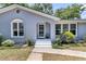 Charming home painted in light blue with white trim, lush landscaping, and a welcoming entrance at 1406 Glencoe Dr, Mount Pleasant, SC 29464