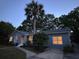 Charming home exterior at twilight featuring a well-kept lawn and mature trees at 1406 Glencoe Dr, Mount Pleasant, SC 29464