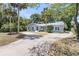 Charming home with a well-maintained lawn, mature trees, and a circular driveway at 1406 Glencoe Dr, Mount Pleasant, SC 29464