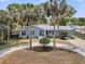 Charming blue home featuring palm trees and a circular driveway for easy access at 1406 Glencoe Dr, Mount Pleasant, SC 29464