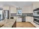 Well-lit kitchen features stainless steel appliances, granite countertops, and custom cabinets at 1406 Glencoe Dr, Mount Pleasant, SC 29464