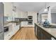 An airy kitchen with stainless steel appliances, granite counters, wooden floors, and lots of storage at 1406 Glencoe Dr, Mount Pleasant, SC 29464