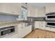 Bright kitchen with stainless steel appliances, lots of cabinets, granite countertops and a farmhouse sink at 1406 Glencoe Dr, Mount Pleasant, SC 29464