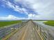 Scenic view of the marsh with expansive wooden bridge under a beautiful blue sky filled with white fluffy clouds at 1406 Glencoe Dr, Mount Pleasant, SC 29464