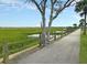 Scenic path along a marsh with a rope fence and view of distant houses, offering a tranquil nature experience at 1406 Glencoe Dr, Mount Pleasant, SC 29464