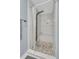 Modern shower featuring pebble flooring, bench, and rainfall shower head at 1406 Glencoe Dr, Mount Pleasant, SC 29464