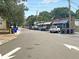 A quiet street view with ample parking and charming storefronts surrounded by lush green trees at 1406 Glencoe Dr, Mount Pleasant, SC 29464
