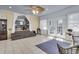 Bright sunroom features tile floors, ceiling fan, and access to dining room with views of the fenced backyard at 1406 Glencoe Dr, Mount Pleasant, SC 29464