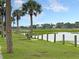Scenic waterfront view with palm trees and a bench on a grassy area, perfect for relaxing and enjoying the scenery at 1406 Glencoe Dr, Mount Pleasant, SC 29464