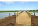 Newly built wooden dock extending over the water, providing access and beautiful views for residents and visitors at 1406 Glencoe Dr, Mount Pleasant, SC 29464