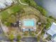 Aerial view of community pool, playground, lake, and walking trails surrounded by lush landscaping at 1445 Lettered Olive Ln, Mount Pleasant, SC 29464