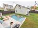 Backyard pool area featuring a pool with fountains, lounge seating, and privacy fence at 1445 Lettered Olive Ln, Mount Pleasant, SC 29464