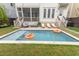 Backyard with an in-ground pool, lounge chairs, and manicured lawn for outdoor relaxation at 1445 Lettered Olive Ln, Mount Pleasant, SC 29464