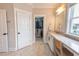 Bright bathroom features a vanity area, marble countertops, and a walk-in closet at 1445 Lettered Olive Ln, Mount Pleasant, SC 29464