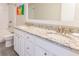 Bathroom with dual sinks, white cabinetry, granite countertops, and a tub shower at 1445 Lettered Olive Ln, Mount Pleasant, SC 29464
