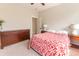 Bedroom with wood furnishings, red and white bedding, and neutral walls and carpet at 1445 Lettered Olive Ln, Mount Pleasant, SC 29464