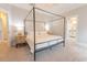 Bedroom featuring a canopy bed, neutral decor, and a doorway leading to an ensuite bathroom at 1445 Lettered Olive Ln, Mount Pleasant, SC 29464
